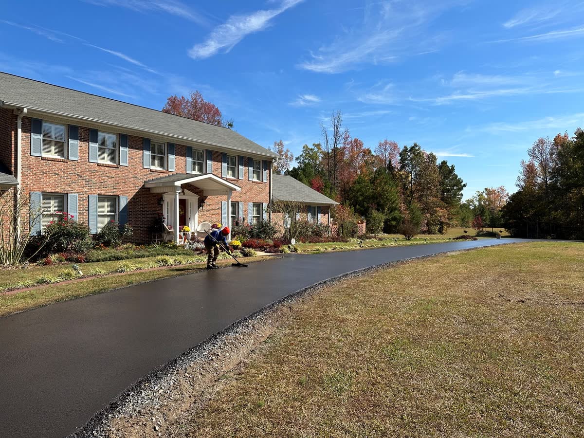 Driveway after sealcoat application showing a wet-look black finish